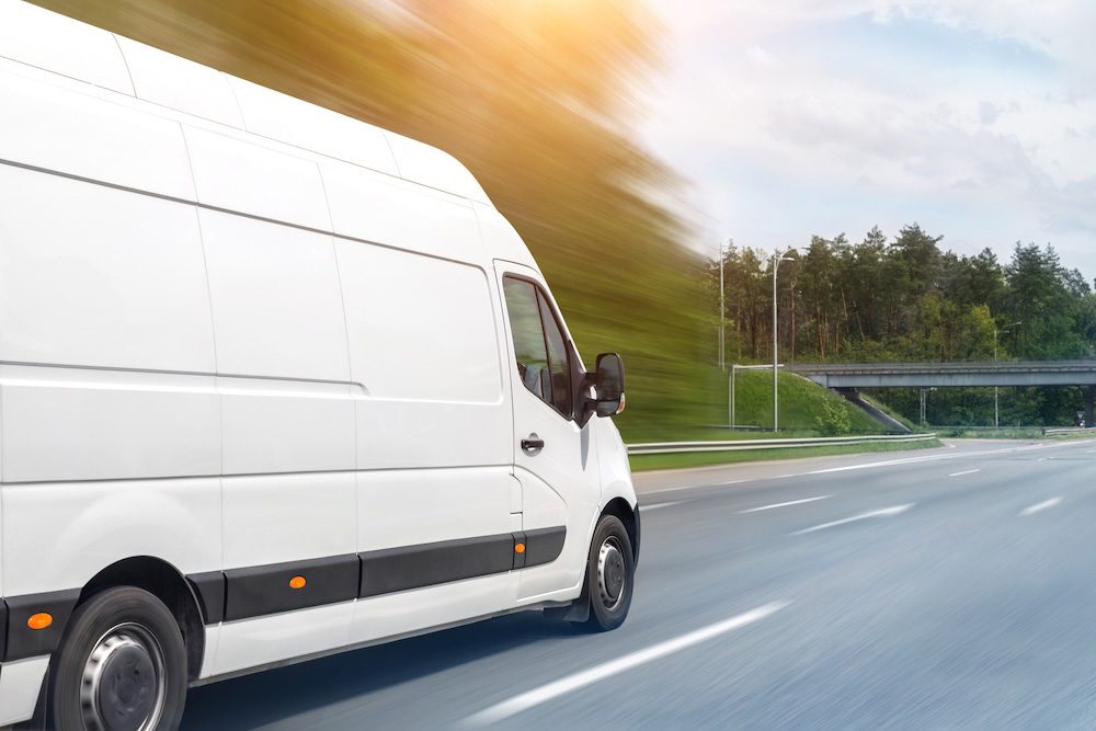 White service van driving on the road for field service operations