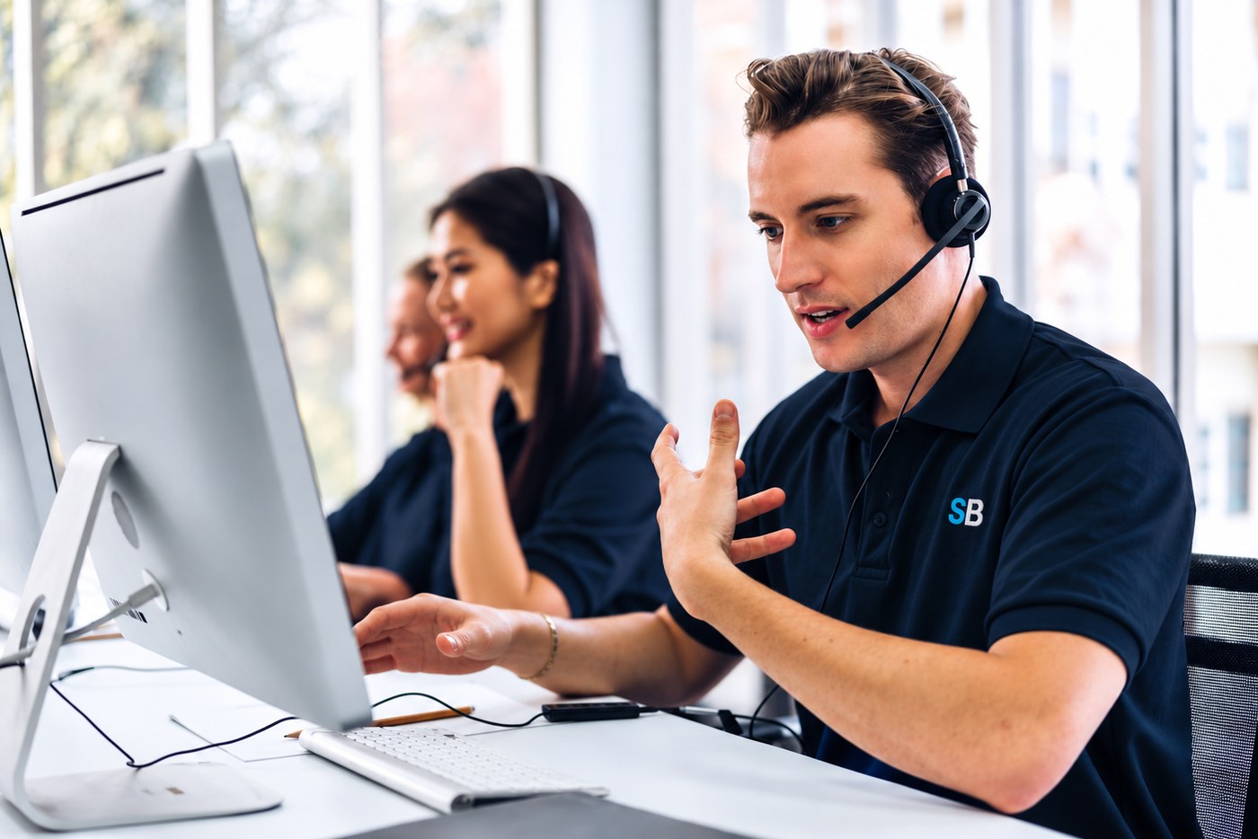 ServiceBridge support team member wearing a headset and assisting customers